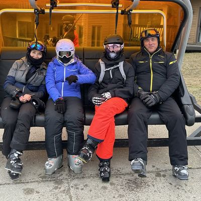 Anfisa and her family on a ski lift bench